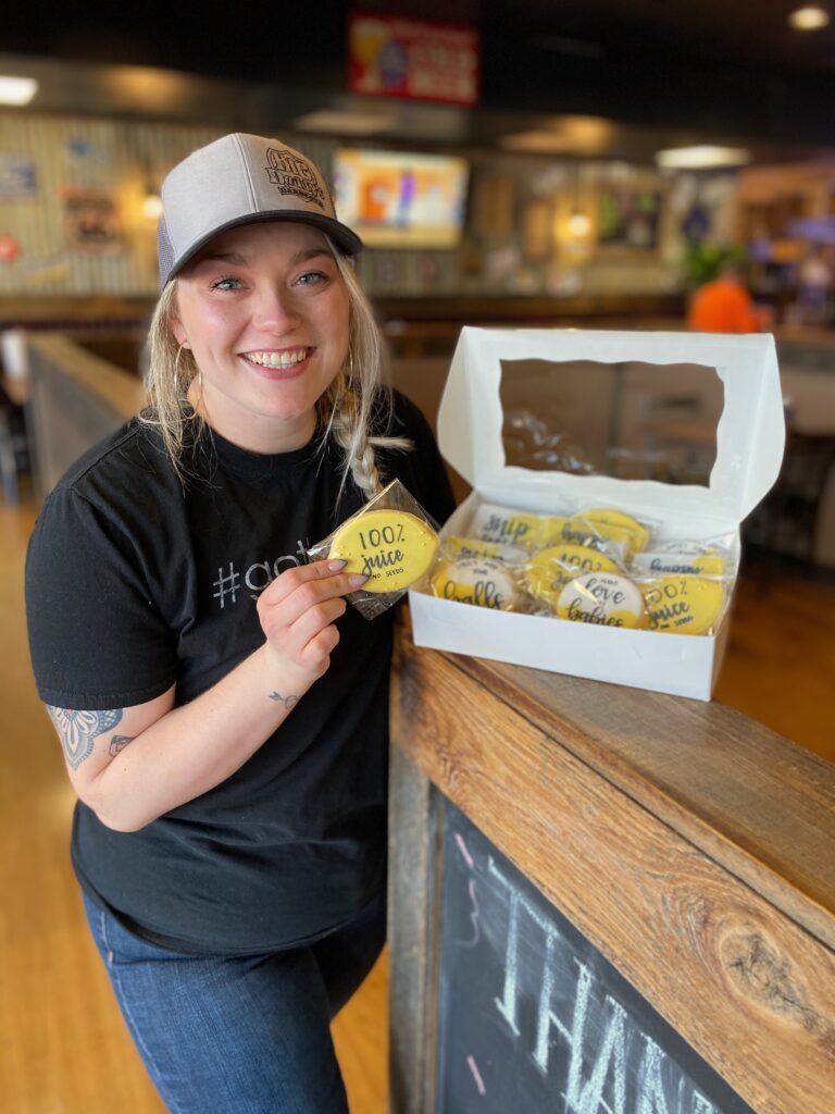 Kersten Grigg holds a box of vasectomy cookies